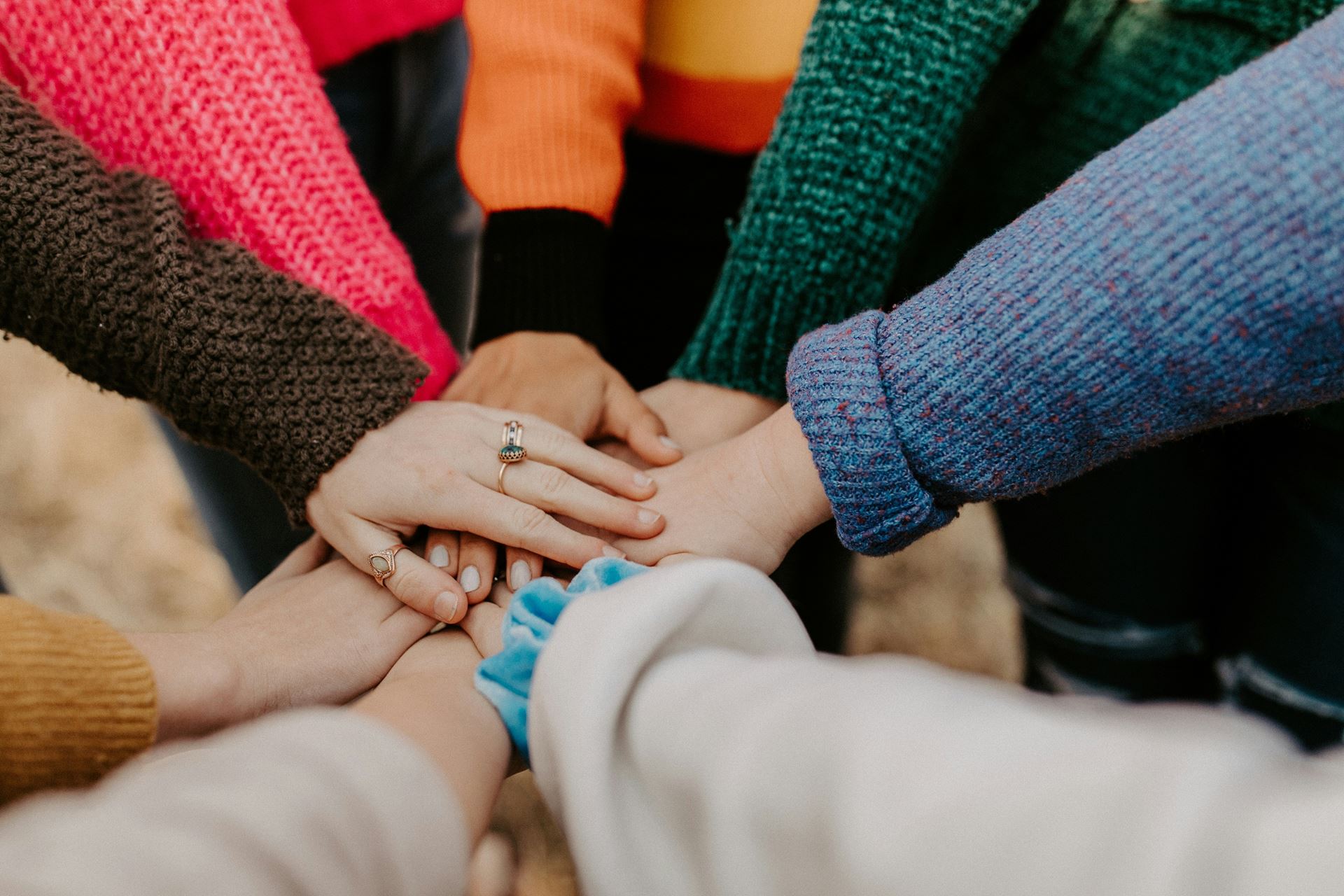 group of people touching hands 